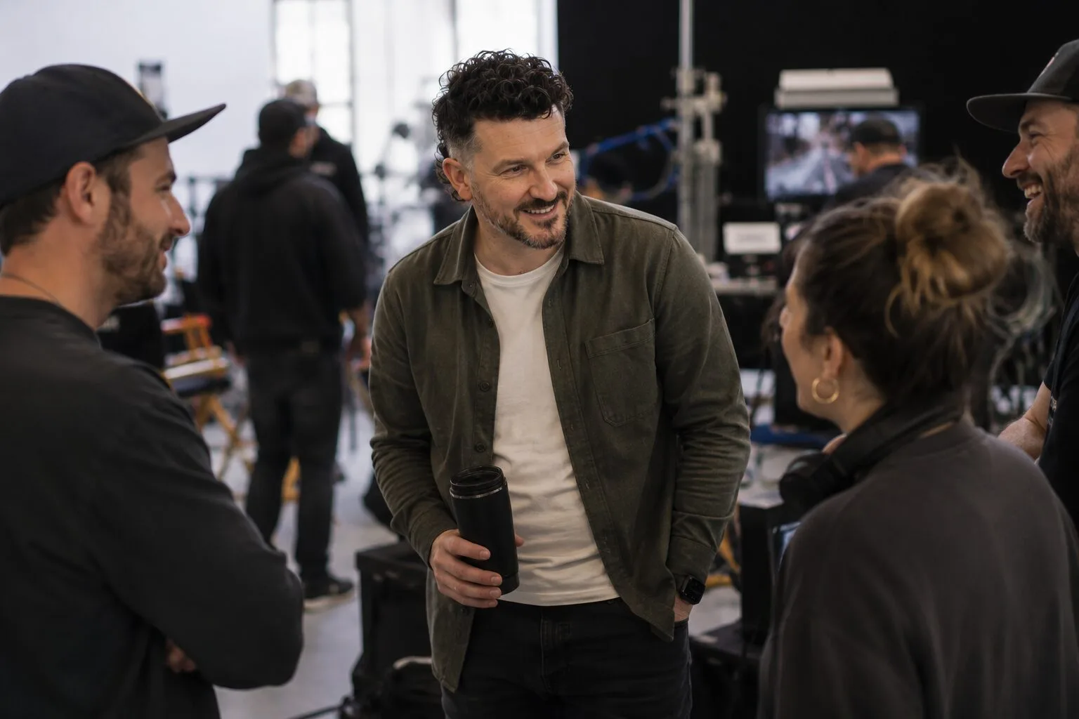 Chris Hatchett laughing with crew between takes on set